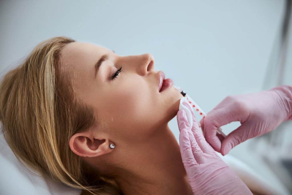 Injecting Dermal filler into the patient lips | Empower Aesthetics and Wellness in Richmond KY